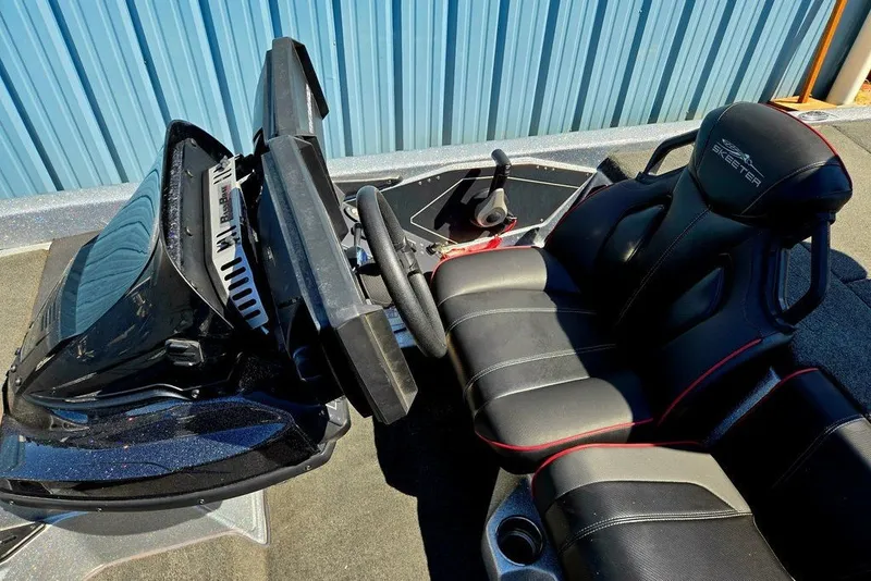Slide: The Image of 2026 Skeeter ZXR21 boat cockpit with black leather seats and modern steering console. - 12