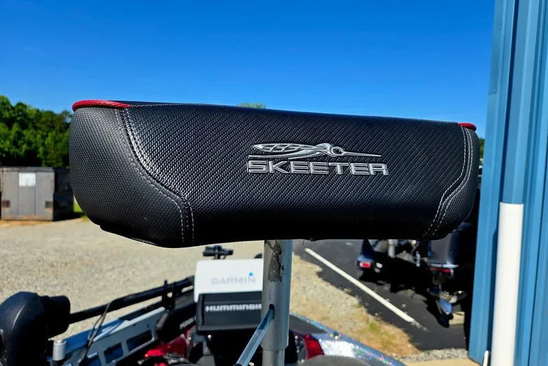 Slide: The Image of Skeeter ZXR21 2026 boat seat with logo, outdoors under clear blue sky. - 7