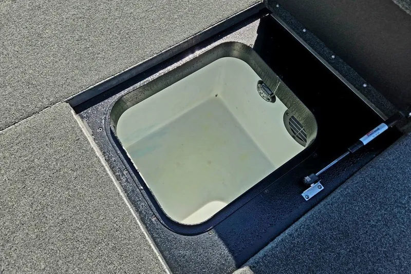 Slide: The Image of Open storage compartment in 2026 Skeeter ZXR21 boat, featuring a hydraulic lift. - 40
