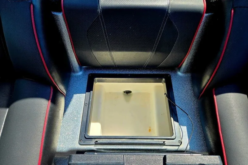 Slide: The Image of Skeeter ZXR21 2026 boat interior with open storage compartment, black and red seating. - 45