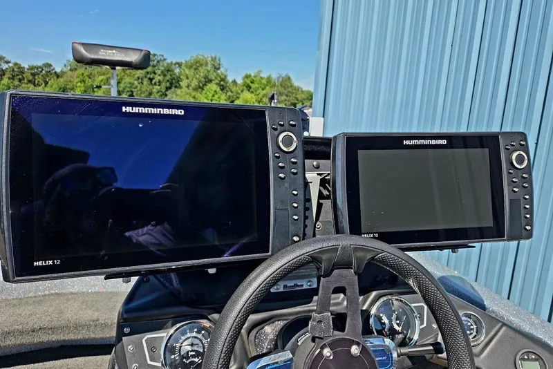 Slide: The Image of Dual Humminbird Helix displays on a 2026 Skeeter ZXR21 boat dashboard. - 38