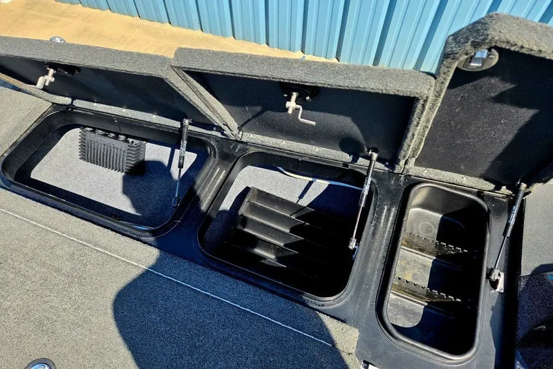 Slide: The Image of Open storage compartments on a 2026 Skeeter ZXR21 boat, showcasing interior design. - 15