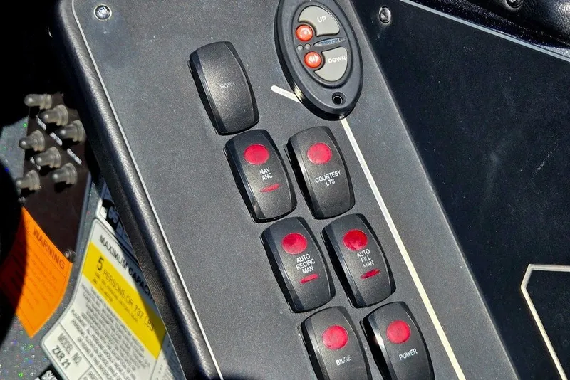 Slide: The Image of Control panel of a 2026 Skeeter ZXR21 boat with labeled switches and buttons. - 41