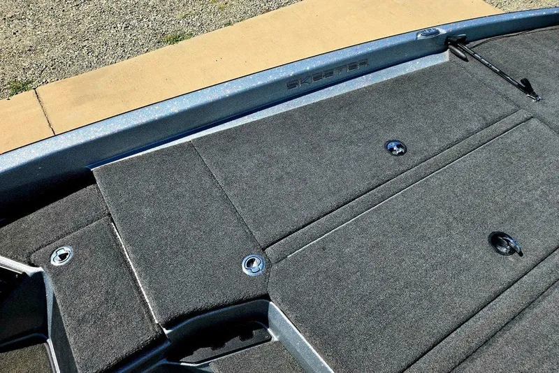 Slide: The Image of 2026 Skeeter ZXR21 boat deck with carpeted storage compartments and sleek design. - 14