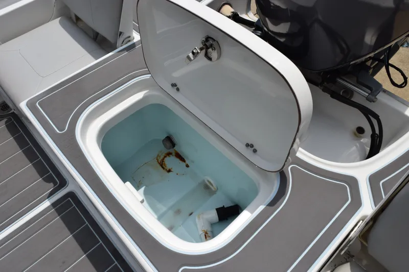 Slide: The Image of Open storage compartment on a 2016 Sea Hunt BX22BR boat, showing interior details. - 20