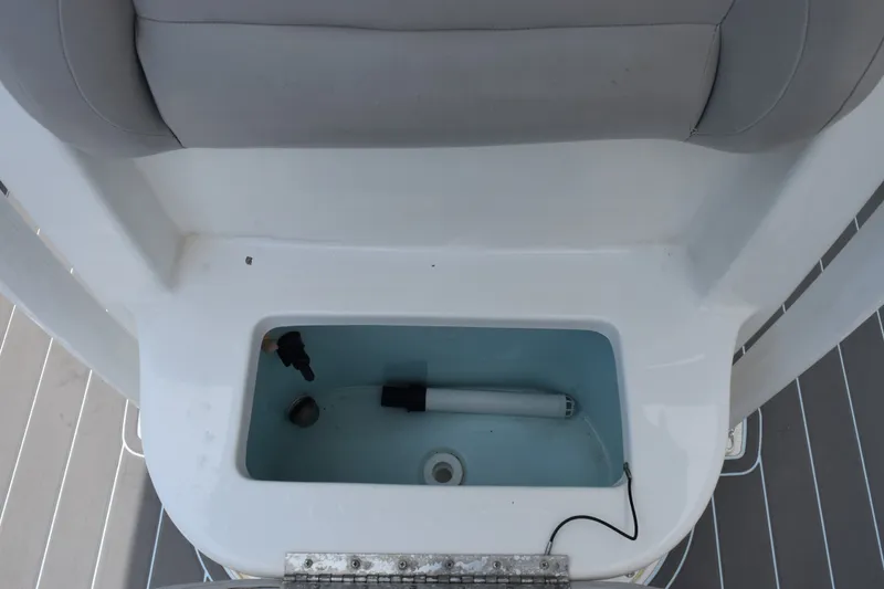 Slide: The Image of Livewell compartment on a 2016 Sea Hunt BX22BR boat, featuring a clean interior. - 15