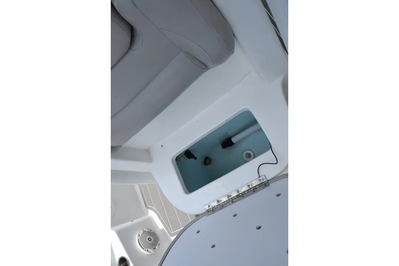 Slide: The Image of 2016 Sea Hunt BX22BR boat interior with storage compartment and seating. - 19