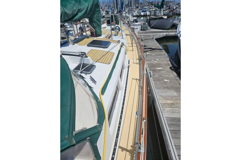 Slide: The Image of 1988 Hans Christian Christina sailboat docked at marina, showcasing deck and rigging. - 41
