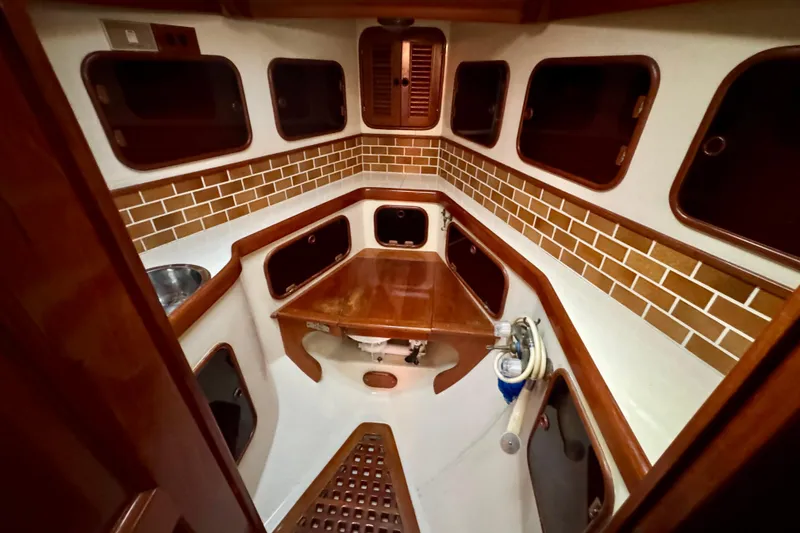 Slide: The Image of Interior of 1988 Hans Christian Christina sailboat with wooden cabinetry and tiled walls. - 21
