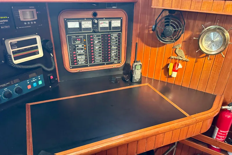 Slide: The Image of Navigation station of 1988 Hans Christian Christina sailboat with control panels and equipment. - 14