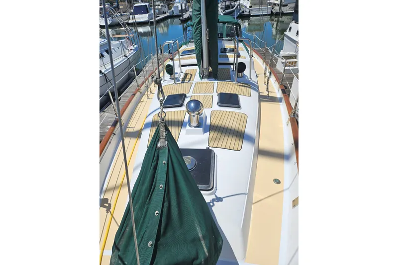 Slide: The Image of 1988 Hans Christian Christina sailboat deck with green sail cover in marina. - 39