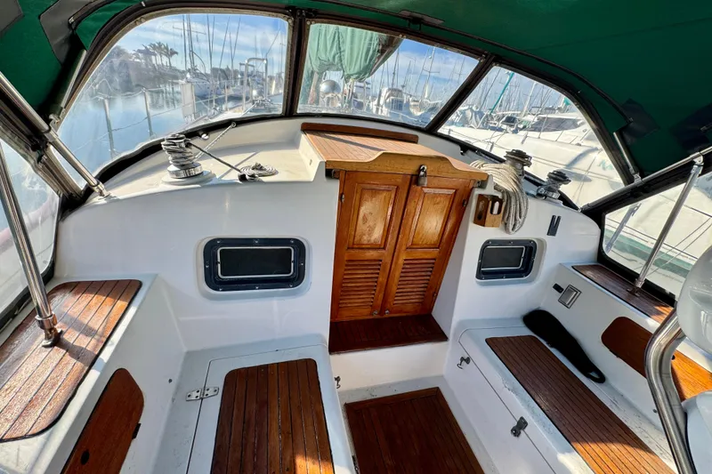Slide: The Image of Cockpit of 1988 Hans Christian Christina sailboat with wooden accents and marina view. - 28