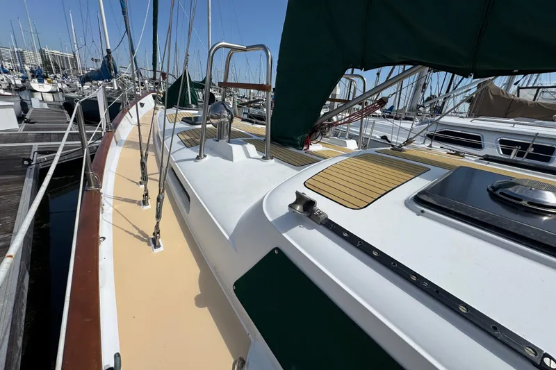 Slide: The Image of 1988 Hans Christian Christina sailboat docked at marina, showcasing deck and rigging. - 34