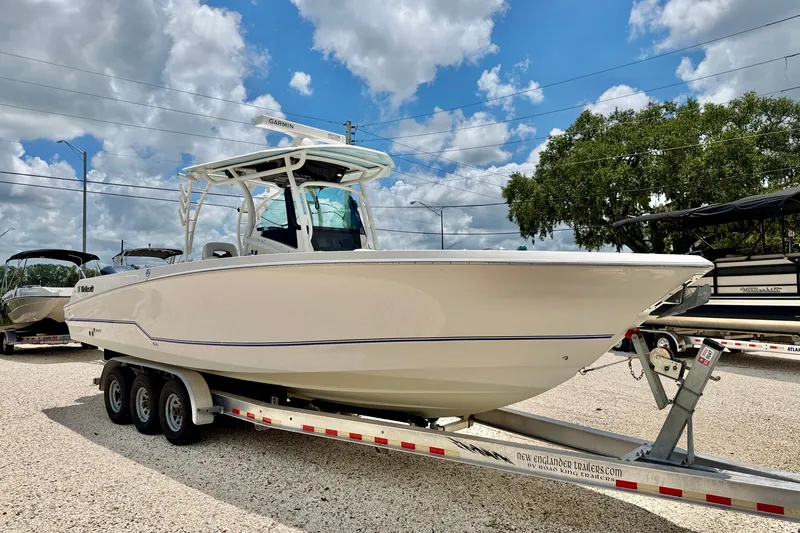 Slide: The Image of 2018 Wellcraft 302 Fisherman boat on trailer under cloudy sky. - 3