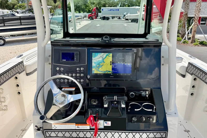 Slide: The Image of 2018 Wellcraft 302 Fisherman helm with navigation display and steering wheel. - 19