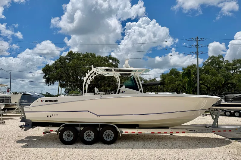 Slide: The Image of 2018 Wellcraft 302 Fisherman boat on trailer under blue sky. - 4