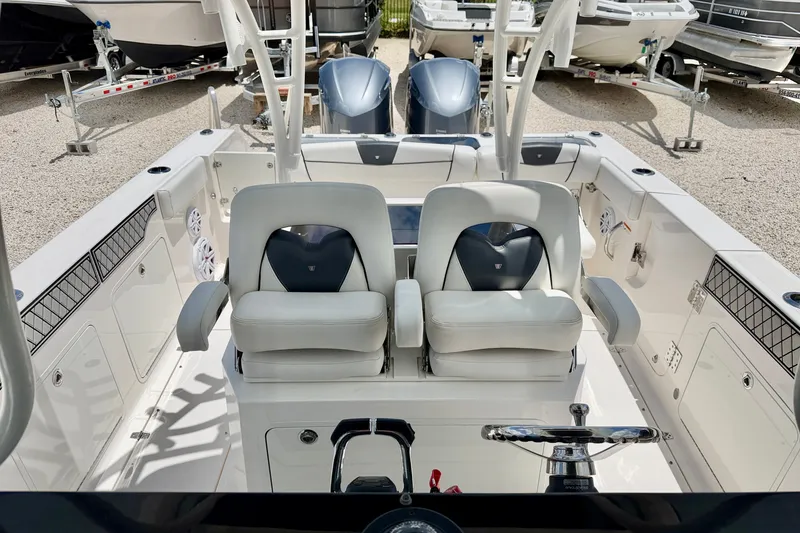 Slide: The Image of 2018 Wellcraft 302 Fisherman boat interior with dual seats and steering wheel. - 16