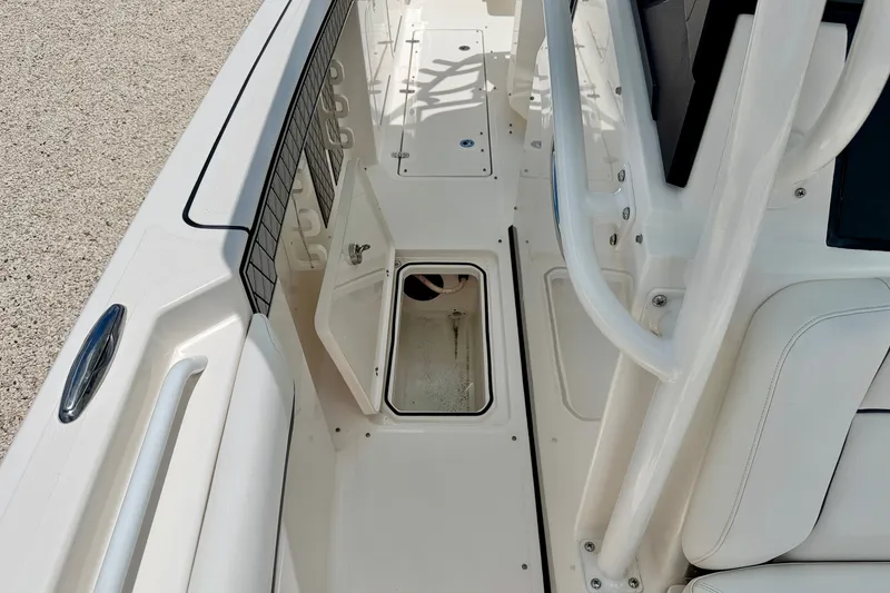 Slide: The Image of 2018 Wellcraft 302 Fisherman boat interior with open storage compartment and seating area. - 42