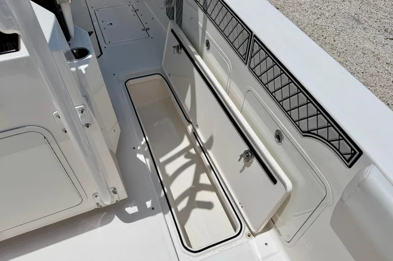 Slide: The Image of 2018 Wellcraft 302 Fisherman boat interior storage compartment with open hatch. - 45