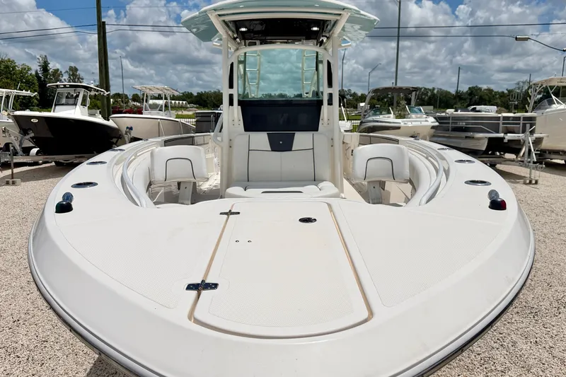 Slide: The Image of 2018 Wellcraft 302 Fisherman boat displayed outdoors under a cloudy sky. - 8
