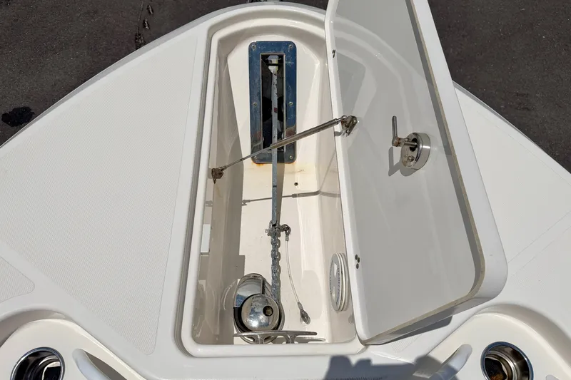 Slide: The Image of Open anchor compartment on 2018 Wellcraft 302 Fisherman boat, showcasing storage and mechanism. - 39