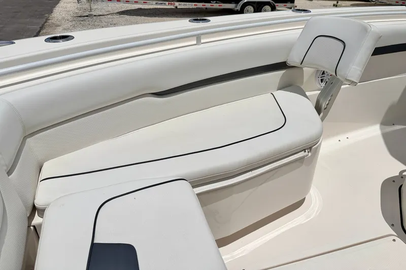 Slide: The Image of 2018 Wellcraft 302 Fisherman boat interior with white cushioned seating and sleek design. - 11