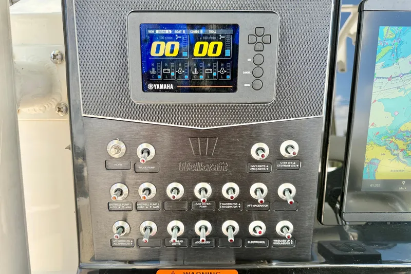 Slide: The Image of Control panel of a 2018 Wellcraft 302 Fisherman boat with Yamaha display and switches. - 21