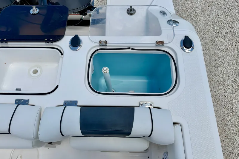 Slide: The Image of 2018 Wellcraft 302 Fisherman boat interior with open storage compartments and seating. - 31