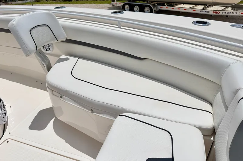 Slide: The Image of 2018 Wellcraft 302 Fisherman boat interior with white cushioned seating. - 10