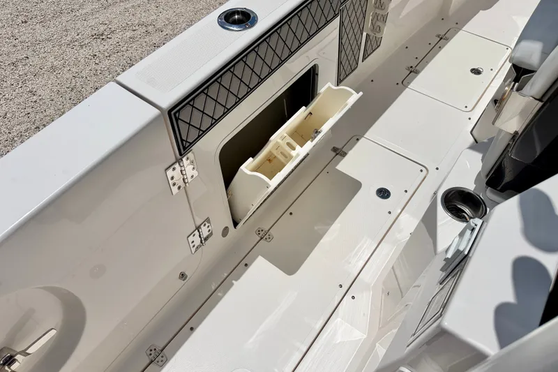 Slide: The Image of 2018 Wellcraft 302 Fisherman boat interior with storage compartments and cup holders. - 46