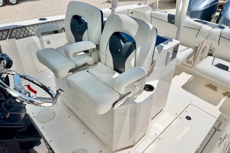 Slide: The Image of 2018 Wellcraft 302 Fisherman boat interior with dual captain's chairs and steering wheel. - 15