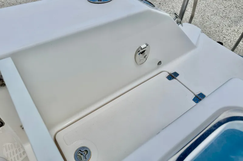 Slide: The Image of 2018 Wellcraft 302 Fisherman boat deck with storage compartment and latch. - 49