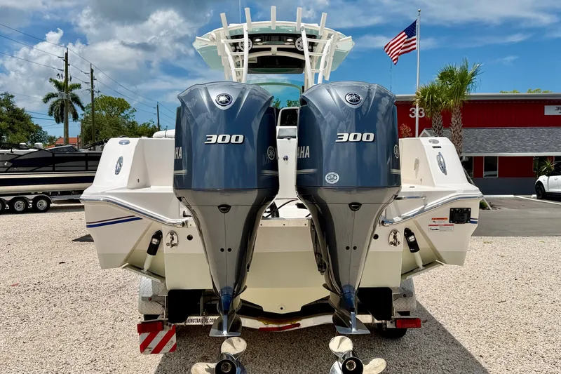 Slide: The Image of 2018 Wellcraft 302 Fisherman boat with dual Yamaha 300 engines, parked outdoors. - 6