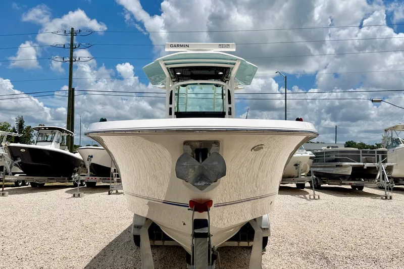 Slide: The Image of 2018 Wellcraft 302 Fisherman boat displayed outdoors under a cloudy sky. - 2