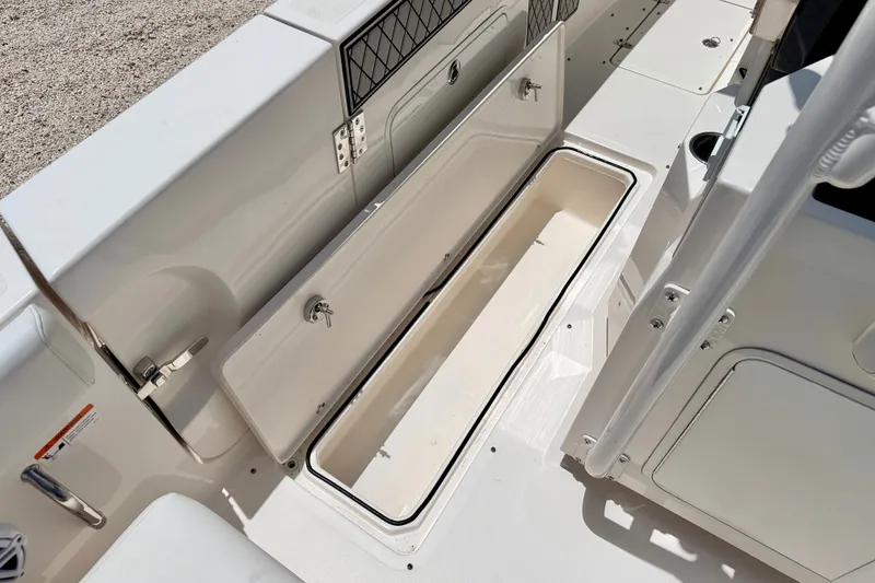 Slide: The Image of 2018 Wellcraft 302 Fisherman boat storage compartment open, showcasing spacious interior. - 47