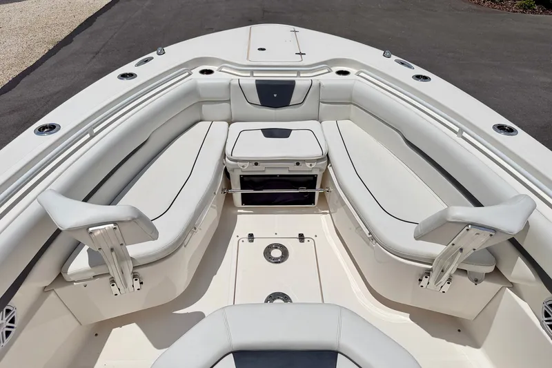 Slide: The Image of 2018 Wellcraft 302 Fisherman boat interior with cushioned seating and storage compartments. - 9