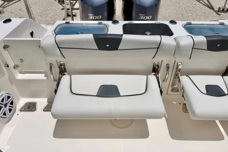 Slide: The Image of 2018 Wellcraft 302 Fisherman boat seating area with Yamaha 300 engines in the background. - 35