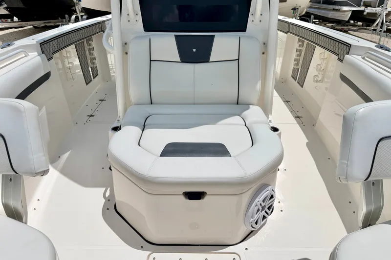 Slide: The Image of 2018 Wellcraft 302 Fisherman boat interior with white seating and storage compartment. - 13