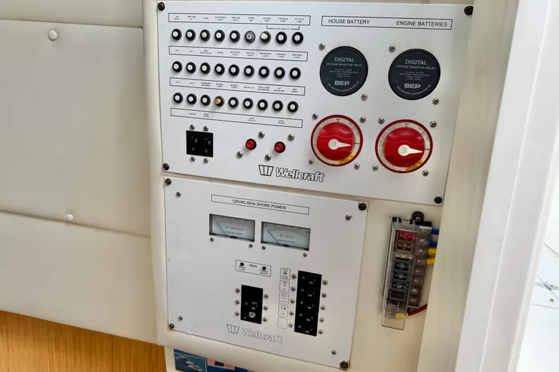 Slide: The Image of Control panel of a 2018 Wellcraft 302 Fisherman boat, featuring battery and power switches. - 34