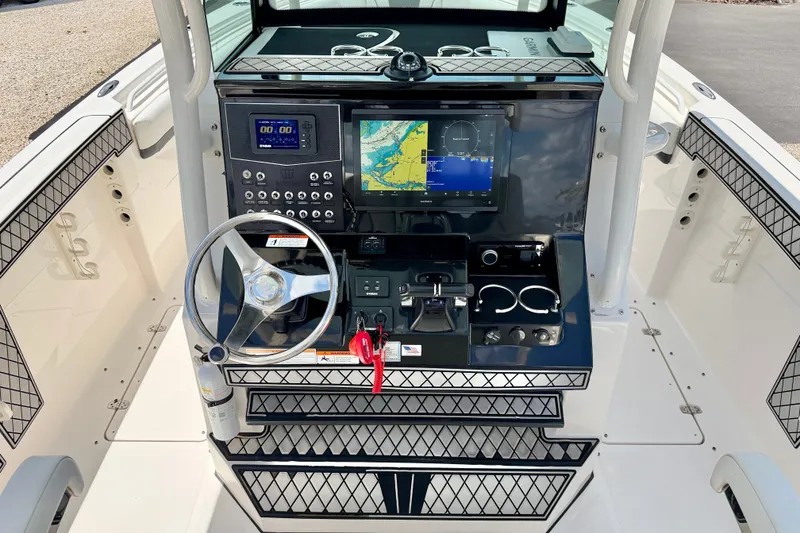 Slide: The Image of 2018 Wellcraft 302 Fisherman boat dashboard with navigation and control systems. - 18