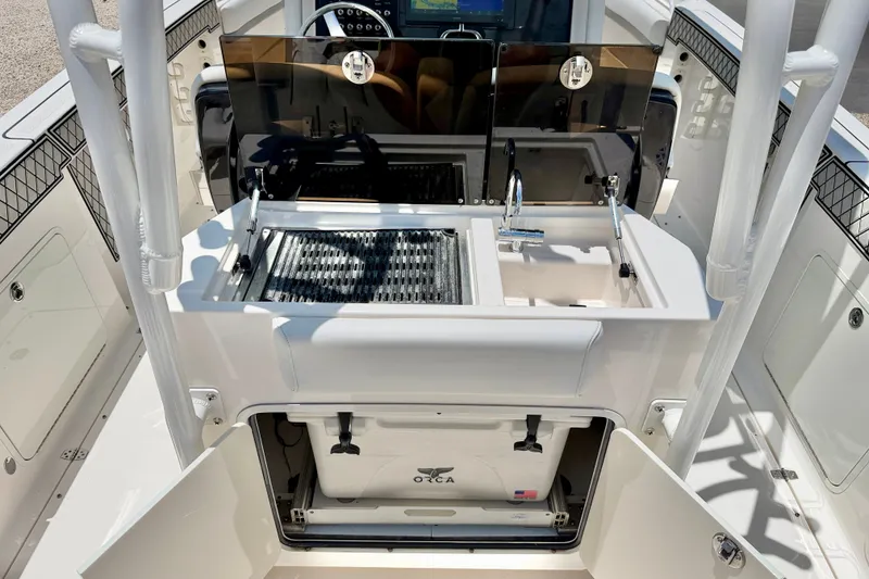 Slide: The Image of 2018 Wellcraft 302 Fisherman boat interior with sink and storage compartments. - 29