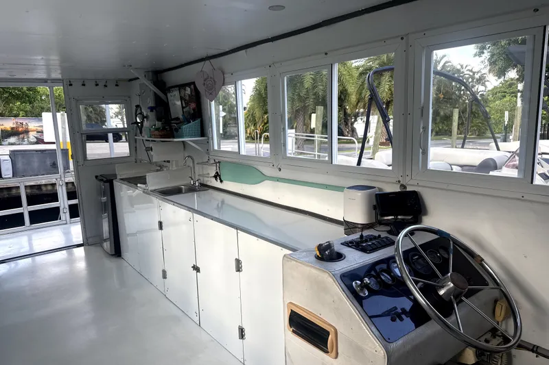 Slide: The Image of Interior of a 1989 Landau 28 Houseboat with kitchen and steering area. - 16