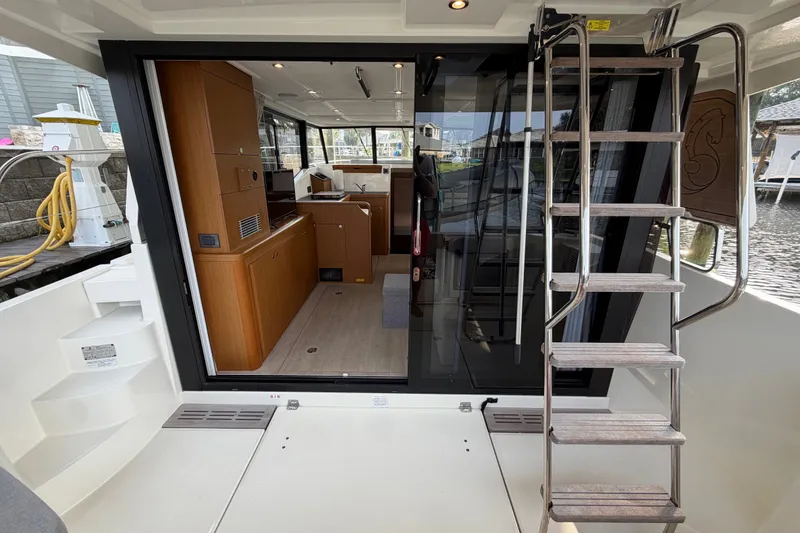 Slide: The Image of 2025 Beneteau Swift Trawler 35 interior view with modern wood cabinetry and sleek design. - 20