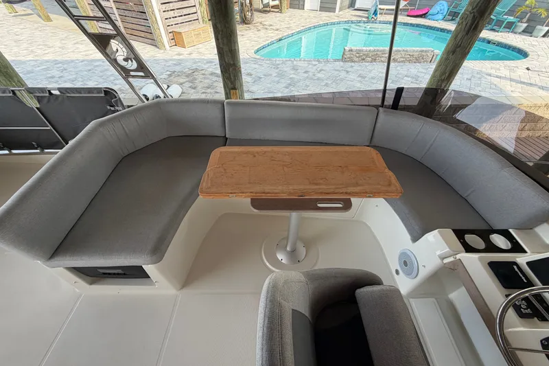 Slide: The Image of Cozy seating area on 2025 Beneteau Swift Trawler 35, overlooking a pool. - 18