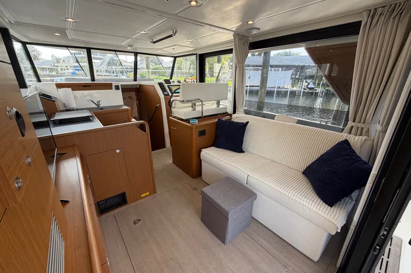 Slide: The Image of Interior of 2025 Beneteau Swift Trawler 35, featuring modern seating and helm station. - 26