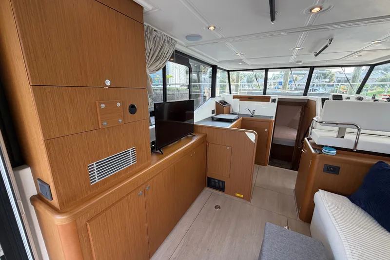 Slide: The Image of Interior of 2025 Beneteau Swift Trawler 35, featuring modern wood cabinetry and spacious layout. - 23