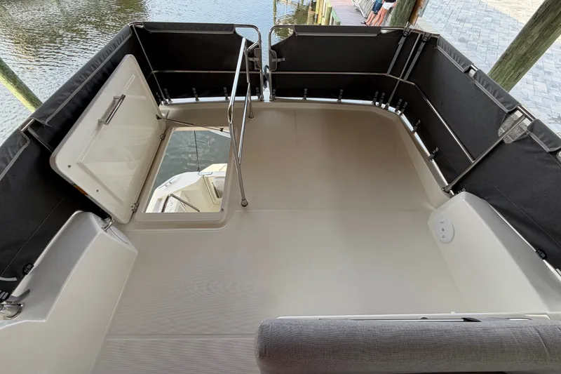 Slide: The Image of 2025 Beneteau Swift Trawler 35 deck with open hatch, dockside view. - 16