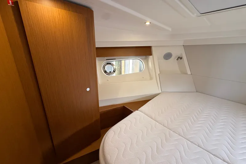 Slide: The Image of Interior cabin of 2025 Beneteau Swift Trawler 35 with wooden accents and cozy bed. - 29
