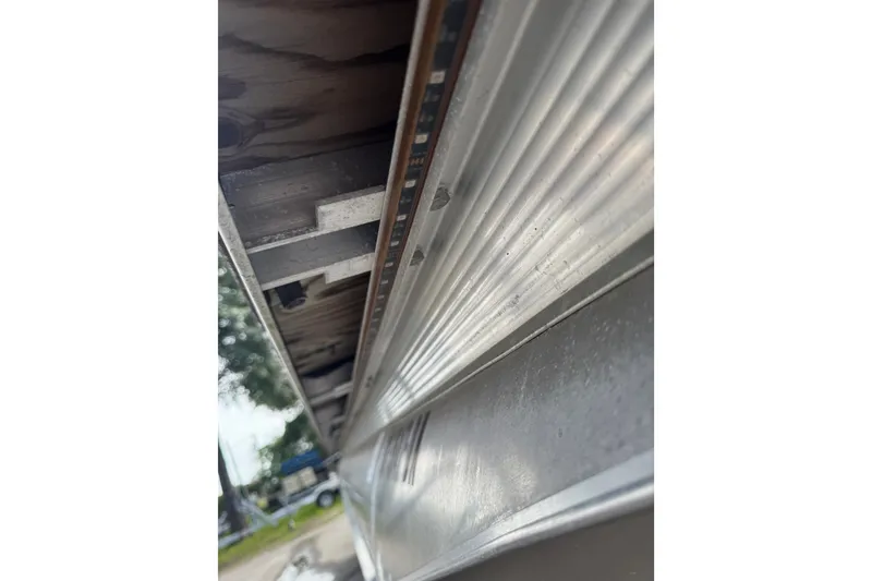 Slide: The Image of Close-up of 2020 Avalon Catalina Platinum Entertainer pontoon's underside, showcasing aluminum structure. - 12