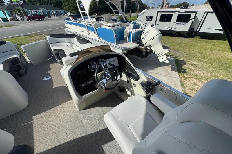 Slide: The Image of 2020 Avalon Catalina Platinum Entertainer boat interior with steering console and seating. - 5